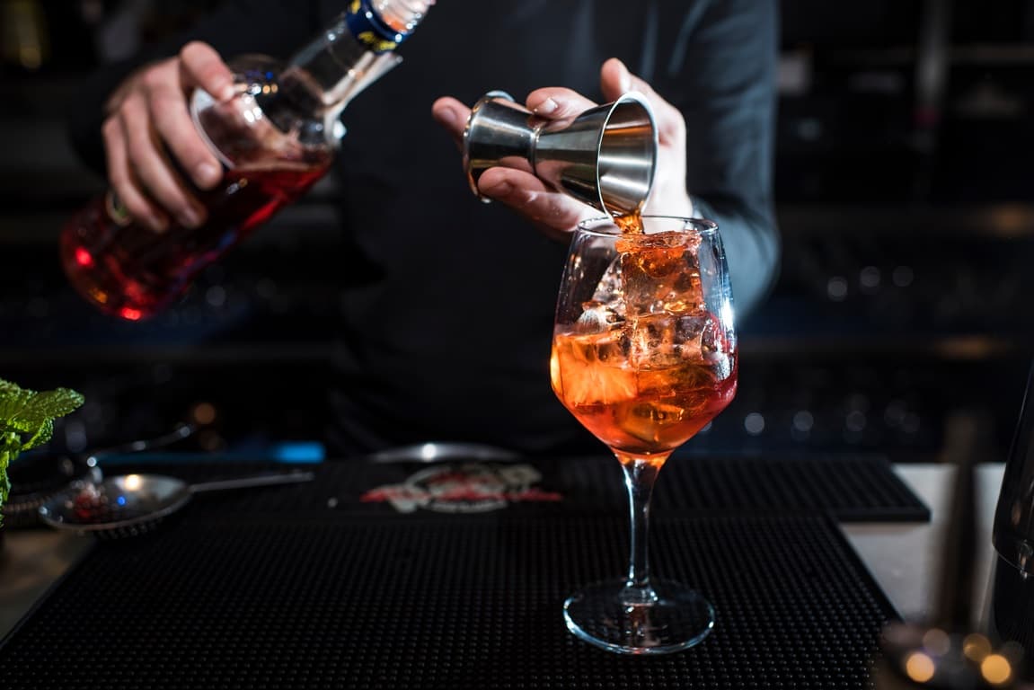 Bartender beim Drink mixen Bartender beim Drink mixen